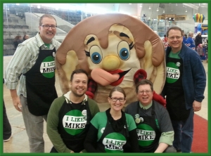 People standing in front of a pancake mascot